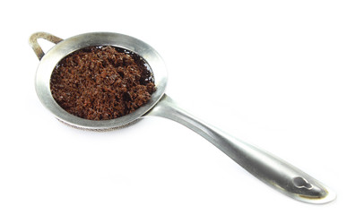 Vintage tea strainer over white background