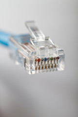 RJ45 cable on gray background. Shallow DOF.