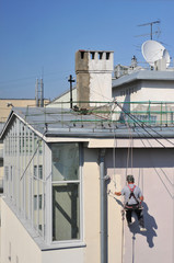 steeplejack paints wall of house