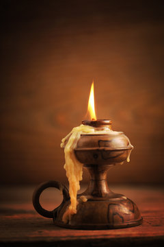 Old Candle On A Wooden Table