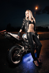 Fototapeta na wymiar Young attractive woman and motorcycle