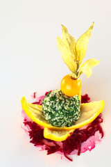Spinach coconut ball garnished with physalis