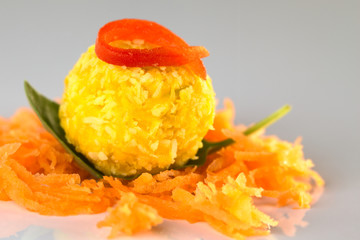 Pumpkin coconut ball with pepper on basil and grated carrot