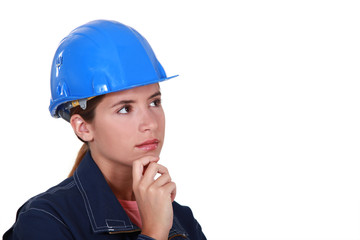 A thoughtful female construction worker.