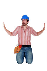 Laborer kneeling on the floor