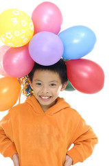 happy boy with colorful balloons over white