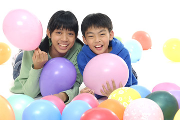 Fototapeta na wymiar Young Children In Studio With Balloons