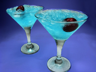 two alcohol blue curacao liqueur cocktails with cherry
