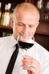 Bar waiter smell glass red wine restaurant