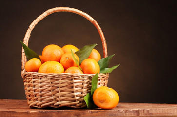 tangerines with leaves in a beautiful basket
