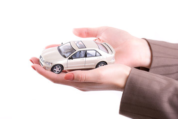 Woman's hands holding the model of car