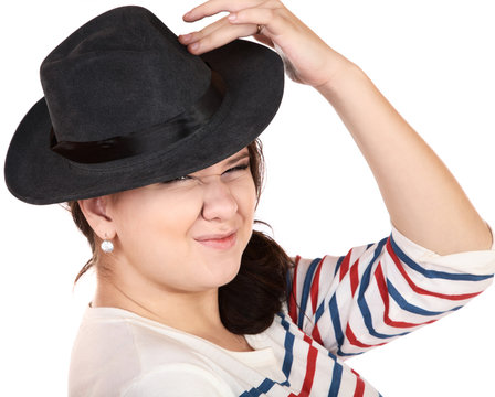 The punch girl in a hat discontentedly wrinkles a nose