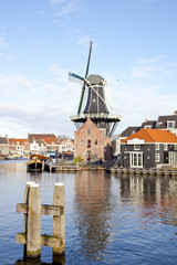 Fototapeta na wymiar Classic windmill at canal in The Netherlands