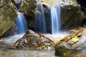 Fototapeta na wymiar nice blue water of stream in autumn forest
