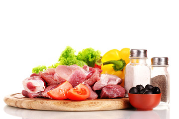 Pieces of raw meat and vegetables