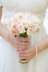 Obraz na płótnie Canvas Wedding bouquet at bride's hands