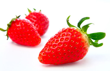 Three stawberries on the white background