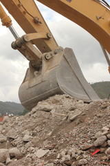 digger with bucket moving earth