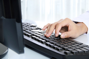 hand typing on the computer keyboard