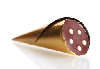Сhocolate candy in the shape of a horn in the gold