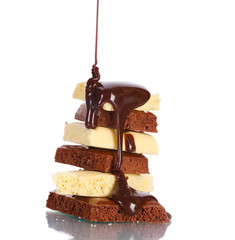 Slices of milk and white chocolate bar poured chocolate isolated