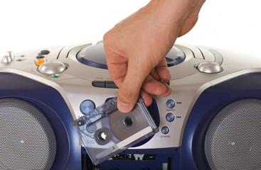 Inserting a cassette into tape recorder