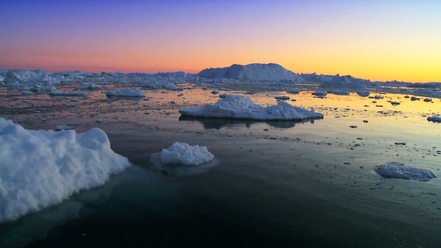 Sun setting over a polar iceberg