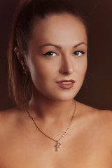 Young brunette lady posing on grey background