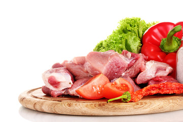 Pieces of raw meat and vegetables