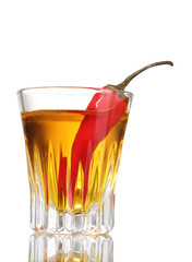 bottle and glass of pepper vodka and red chili pepper isolated