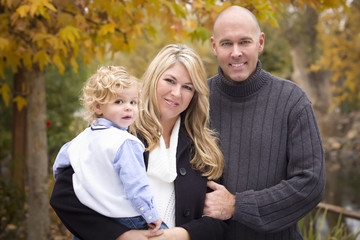 Fototapeta premium Young Attractive Parents and Child Portrait in Park