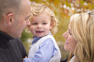 Young Attractive Parents and Child Portrait in Park