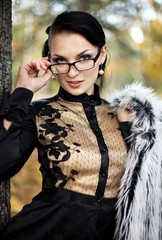 portrait of the young business woman  in autumn park