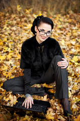 portrait of the young business woman  in autumn park