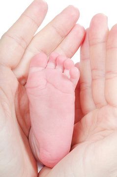 Mother's hands holding baby's feet
