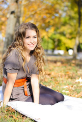 The young beautiful girl in autumn wood