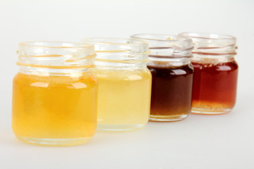 set of jars of honey isolated on white background