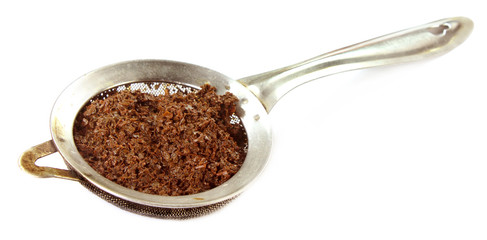 Vintage tea strainer over white background