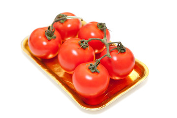 Red tomatoes in plastic plate isolated on white background