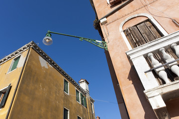 Fototapeta na wymiar Réverbère entre deux façades colorées (Venise)
