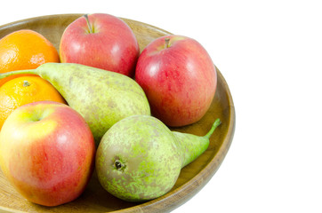 assorted fruit in bowl isolated on white