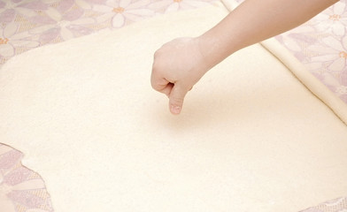 Child's hands kneading dough