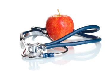Medical stethoscope and red apple isolated on white