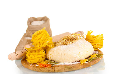 ingredients for homemade pasta on wooden plate isolated on white
