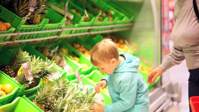 Boy choosing pineapple