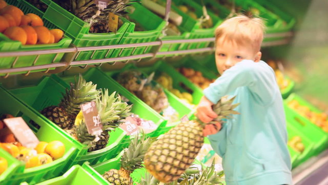 Little boy with pineapple