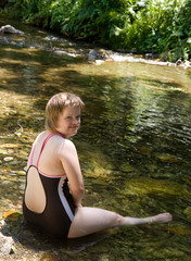 A girl with Down syndrome in the river.