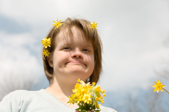 A girl with Down syndrome with flowers in her hair