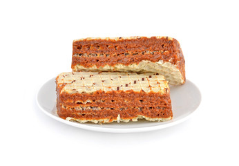 Sweet waffle cake with condensed milk on white