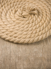 ship ropes and knot on wood
